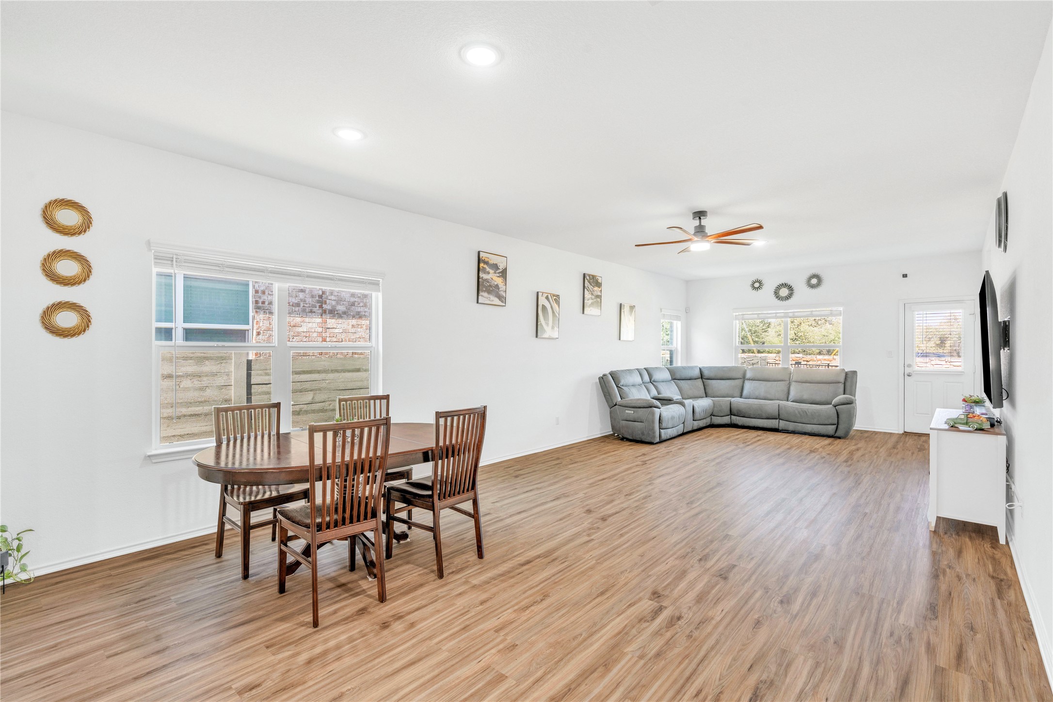 212 Saddle Mountain Road Georgetown, TX 78628 - Photo 15 of 30 Wood flooring and modern recessed lighting enhance this airy open-concept living and dining area.