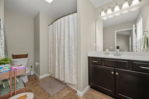 a bathroom with a sink vanity and mirror