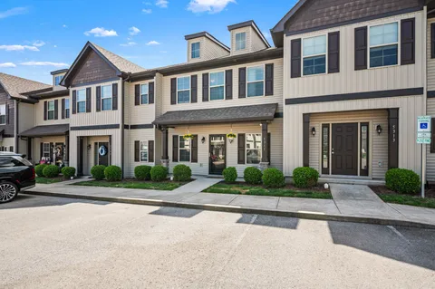 front view of a brick house with a yard