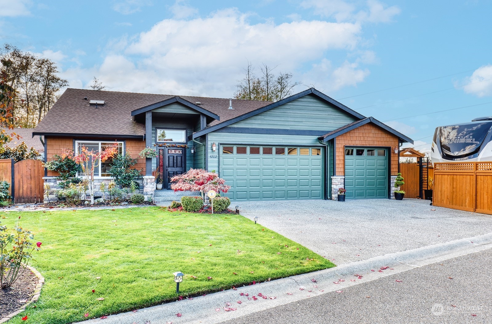 4202 157th Place Southeast Bothell, WA 98012 - Photo 1 of 24 a front view of a house with garden