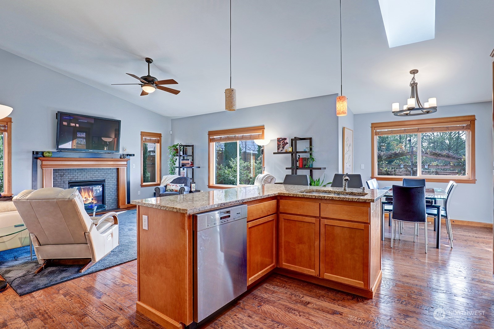 4202 157th Place Southeast Bothell, WA 98012 - Photo 12 of 24 a kitchen with stainless steel appliances granite countertop a table chairs and a refrigerator