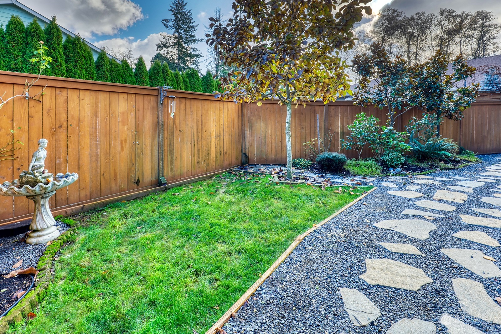 4202 157th Place Southeast Bothell, WA 98012 - Photo 22 of 24 a view of a backyard with potted plants and a large tree