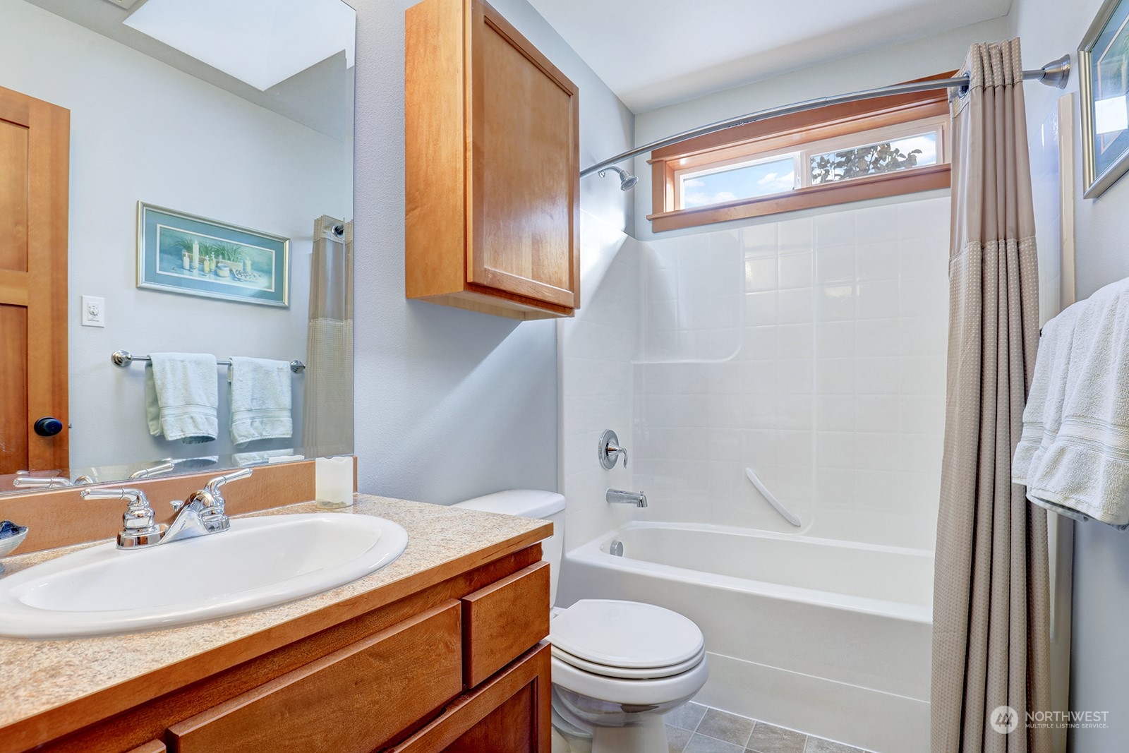 4202 157th Place Southeast Bothell, WA 98012 - Photo 4 of 24 a bathroom with a sink a toilet and shower
