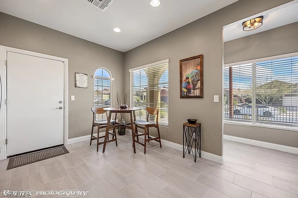 1304 Cottage Ridge Mesquite, NV 89034 - Photo 9 of 52 A welcoming dining area offers durable tile flooring and views of the community through multiple windows.