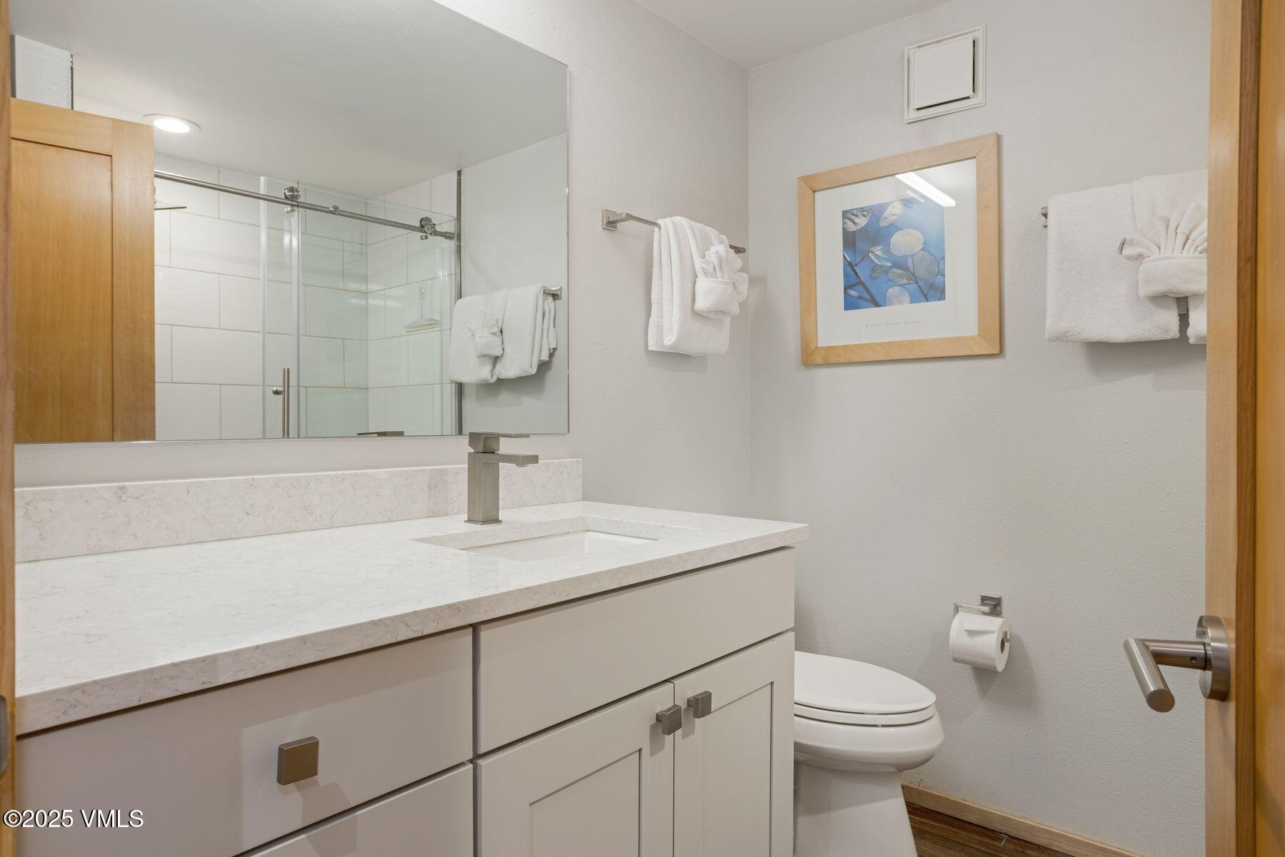 1100 North Frontage Road West, Unit 2311 Vail, CO 81657 - Photo 22 of 34 a bathroom with a sink toilet and vanity