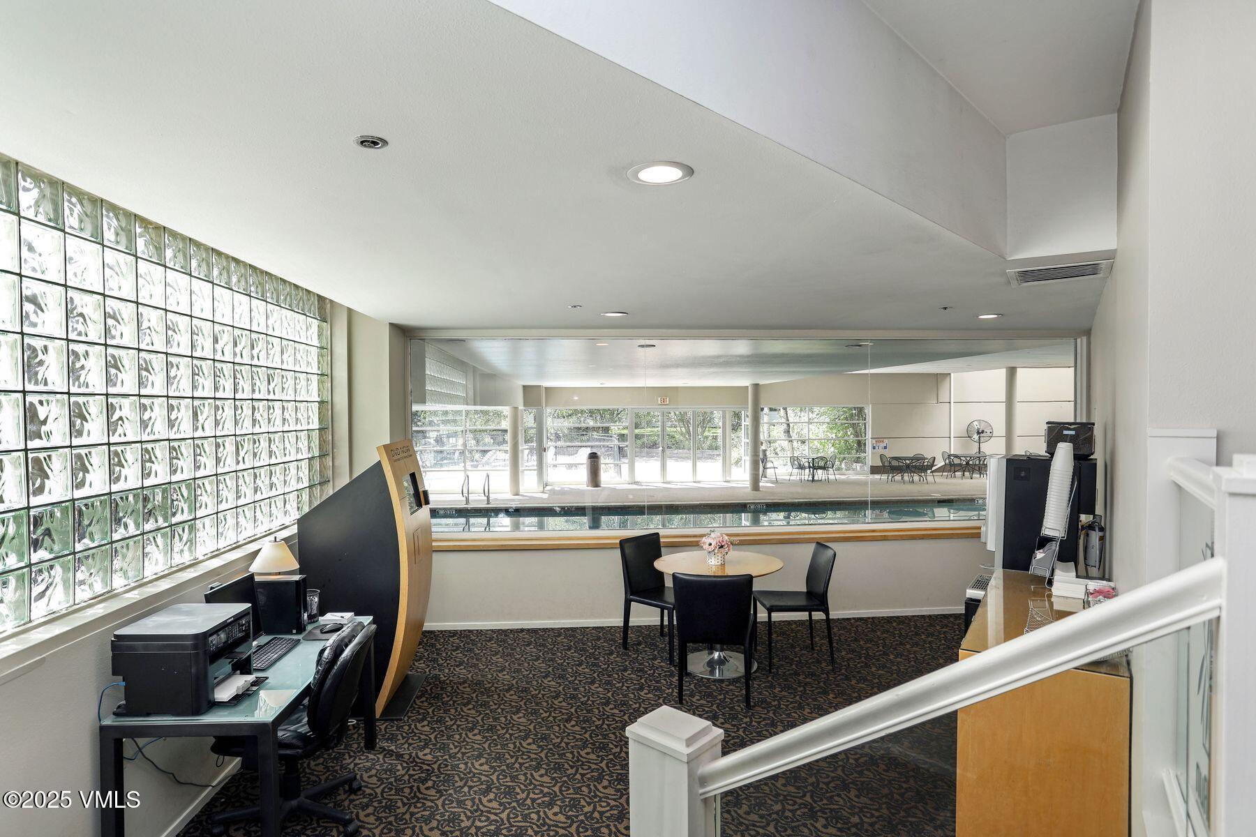 1100 North Frontage Road West, Unit 2311 Vail, CO 81657 - Photo 27 of 34 a dining room with furniture and a floor to ceiling window