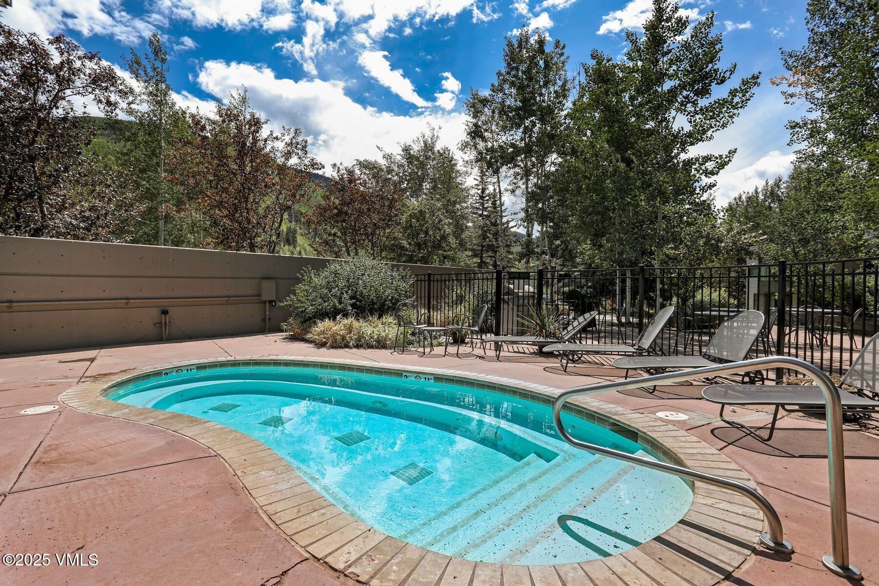 1100 North Frontage Road West, Unit 2311 Vail, CO 81657 - Photo 29 of 34 a view of a swimming pool with lounge chair