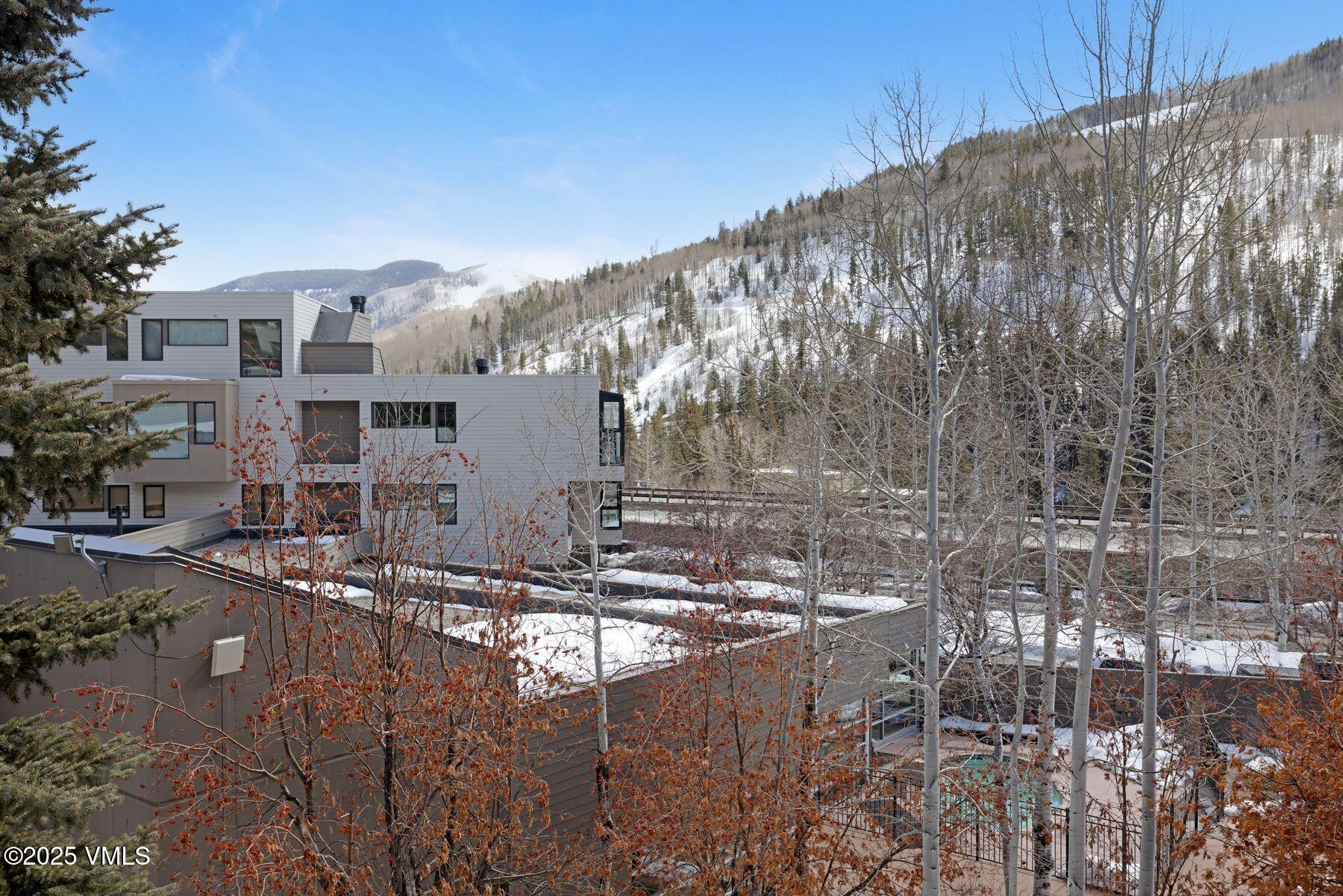 1100 North Frontage Road West, Unit 2311 Vail, CO 81657 - Photo 34 of 34 a large building with trees in front of it