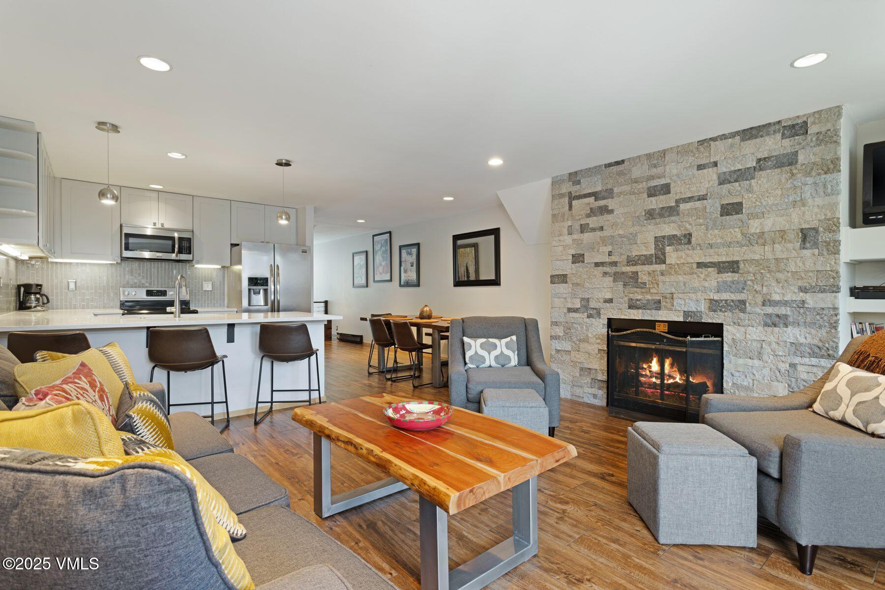 1100 North Frontage Road West, Unit 2311 Vail, CO 81657 - Photo 5 of 34 a living room with furniture and a fireplace