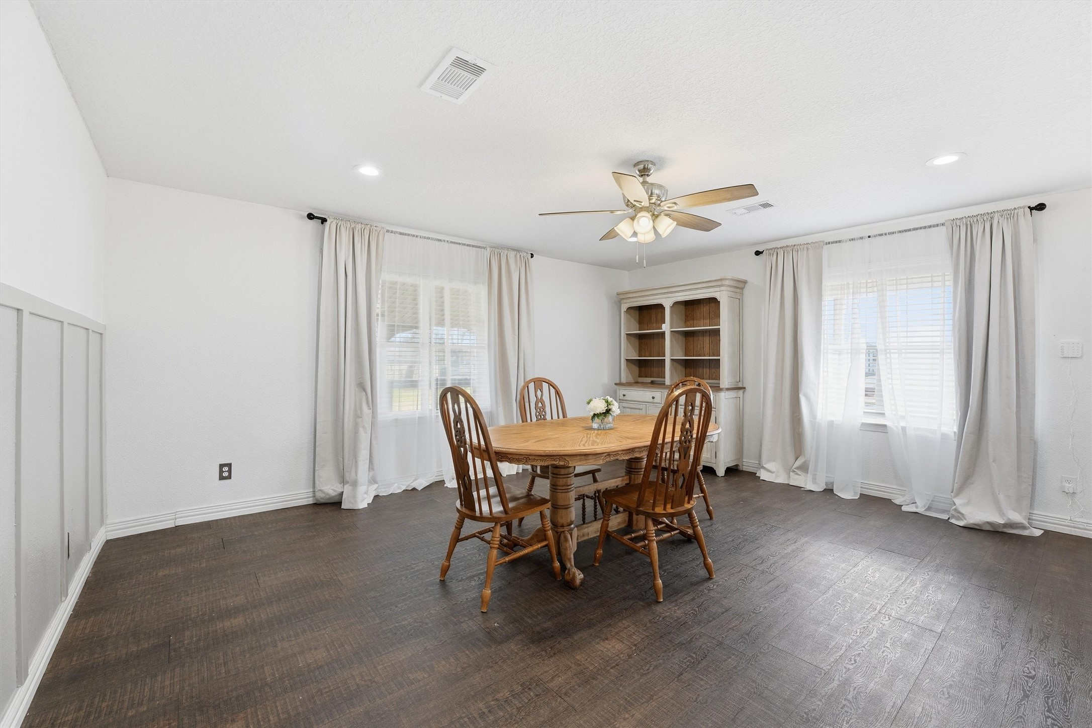611 Reidland Road Crosby, TX 77532 - Photo 8 of 35 Dining area with dark hardwood flooring, neutral walls, and large windows.