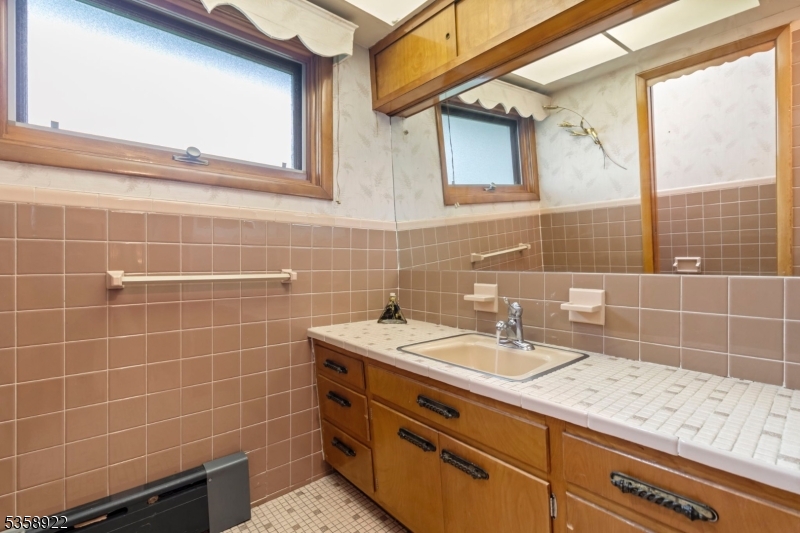 35 Hillside Avenue Netcong, NJ 07857 - Photo 16 of 41 a bathroom with a sink a vanity and a mirror