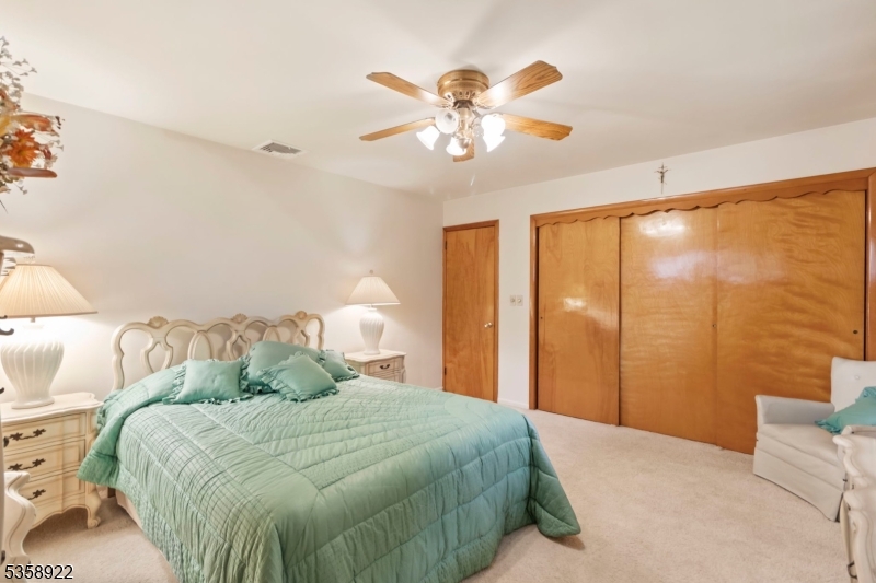 35 Hillside Avenue Netcong, NJ 07857 - Photo 20 of 41 a bedroom with a large bed and a chandelier