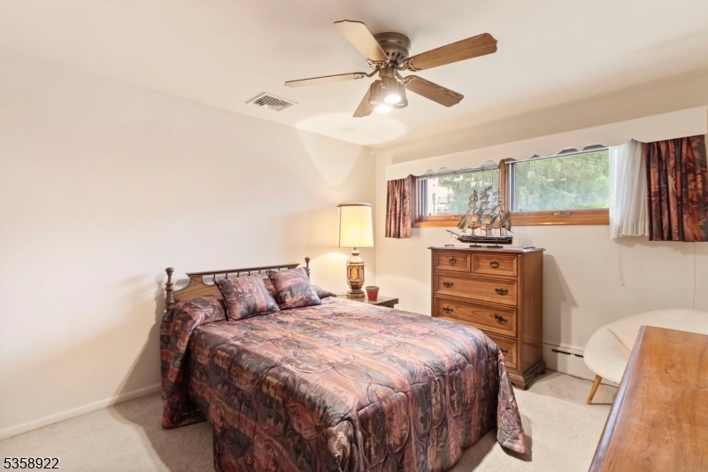 35 Hillside Avenue Netcong, NJ 07857 - Photo 22 of 41 a bedroom with a large bed and a chandelier