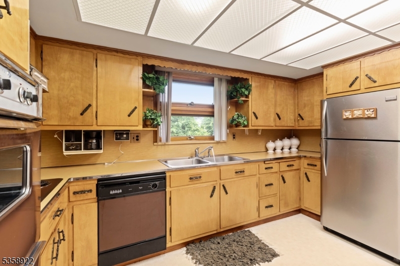 35 Hillside Avenue Netcong, NJ 07857 - Photo 25 of 41 a kitchen with stainless steel appliances granite countertop a refrigerator a sink dishwasher a stove and white countertops with wooden floor