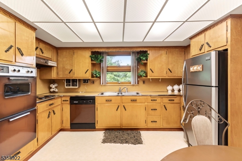 35 Hillside Avenue Netcong, NJ 07857 - Photo 26 of 41 a kitchen with stainless steel appliances granite countertop a stove a sink dishwasher a refrigerator and cabinets with wooden floor