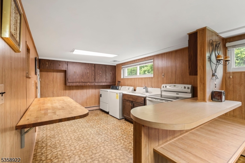 35 Hillside Avenue Netcong, NJ 07857 - Photo 29 of 41 a kitchen with a table chairs refrigerator and stove