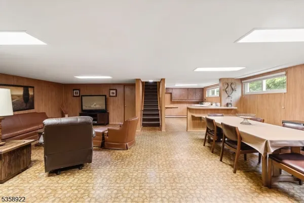 a living room with furniture and a kitchen view