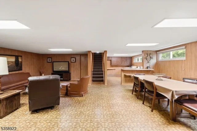 a living room with furniture and a kitchen view
