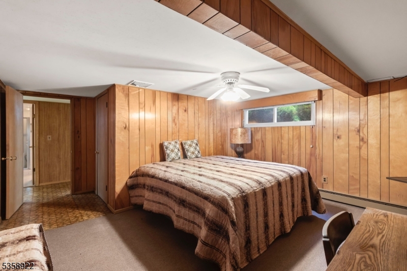 35 Hillside Avenue Netcong, NJ 07857 - Photo 35 of 41 a bedroom with a bed and a chandelier