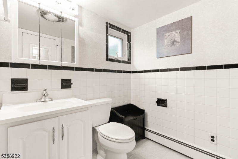 35 Hillside Avenue Netcong, NJ 07857 - Photo 38 of 41 a bathroom with a sink a toilet and a mirror