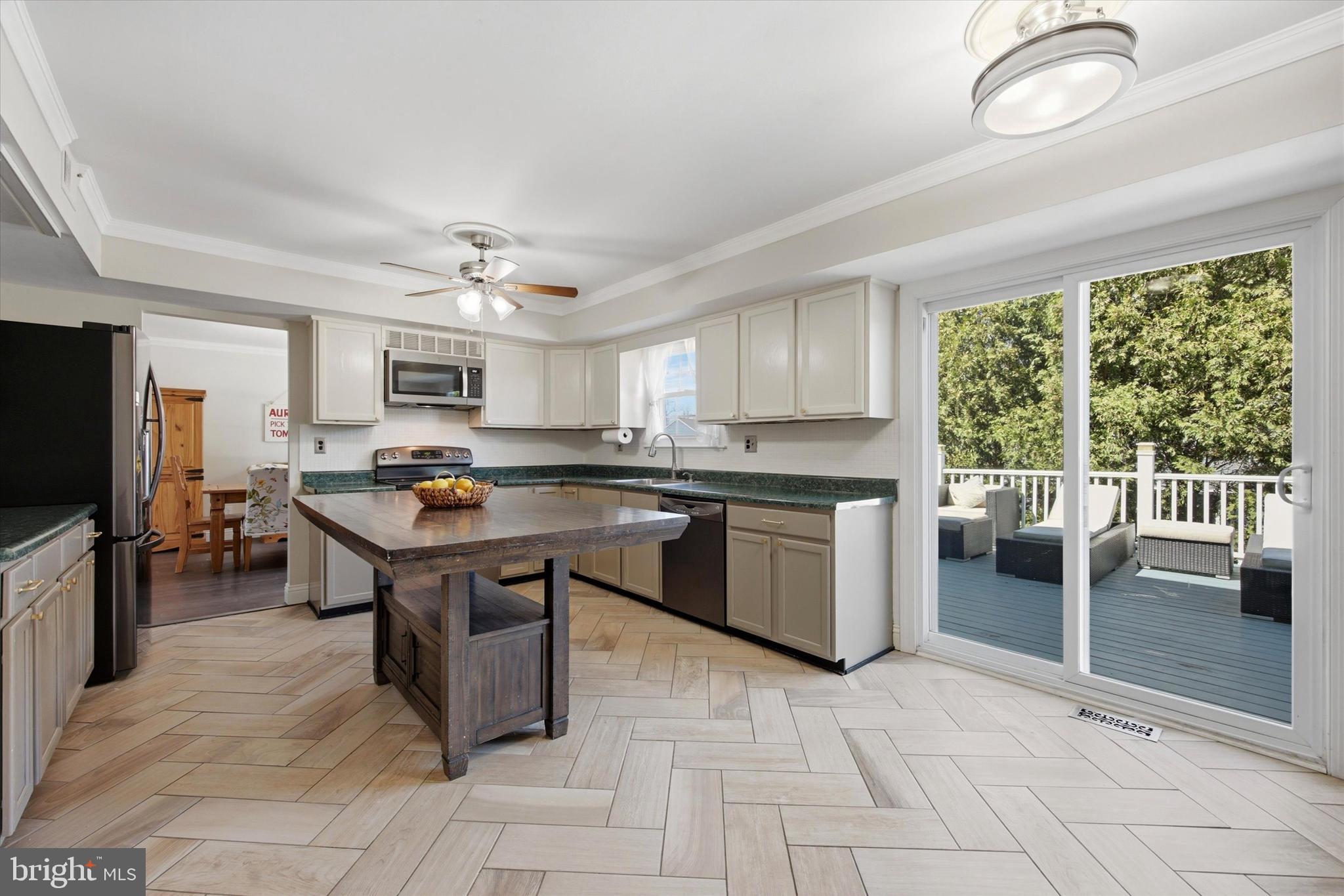1 Country Village Way Media, PA 19063 - Photo 12 of 50 a kitchen with stainless steel appliances granite countertop a stove top oven a sink dishwasher a dining table and chairs with wooden floor