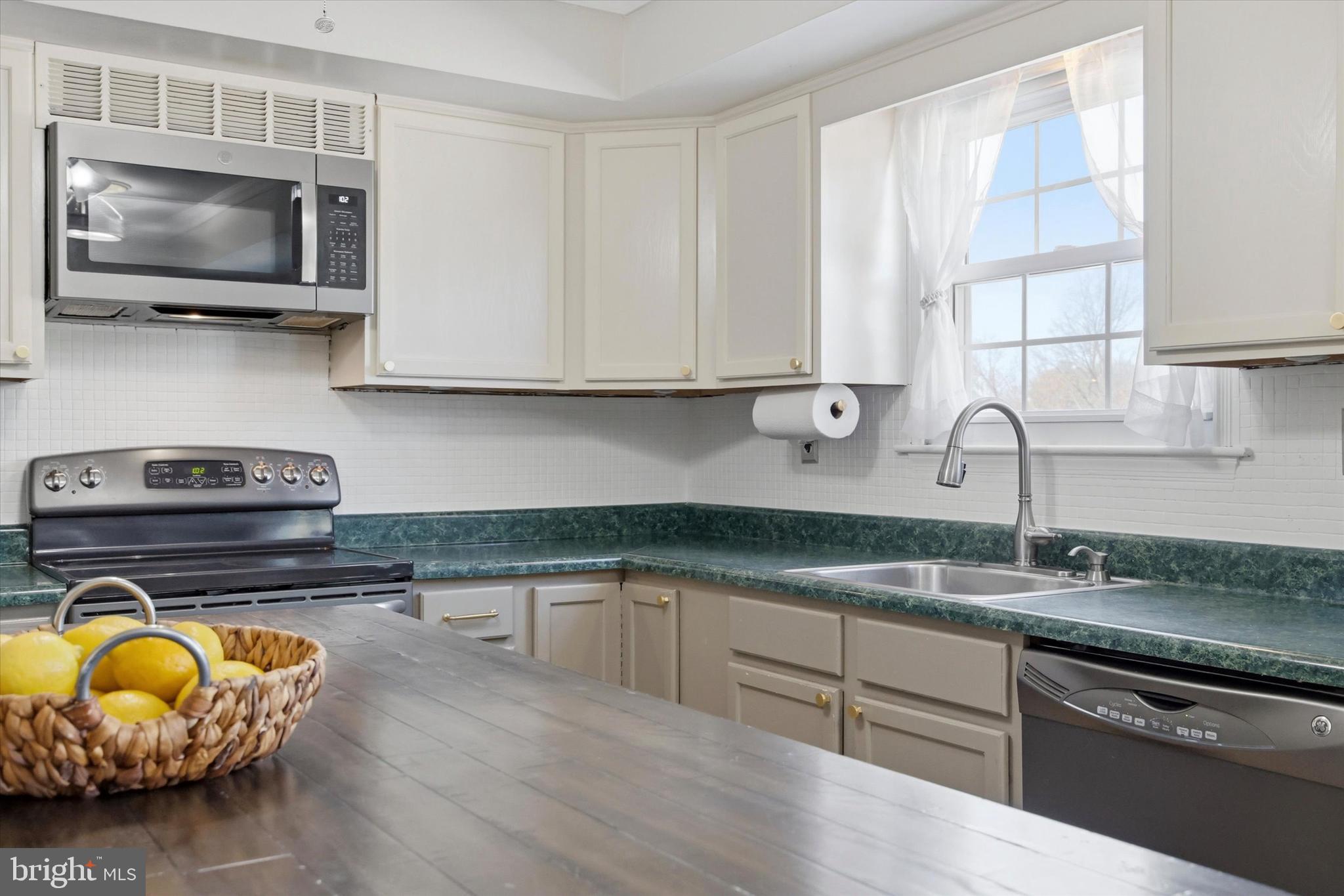 1 Country Village Way Media, PA 19063 - Photo 14 of 50 a kitchen with stainless steel appliances granite countertop a stove a sink and a microwave