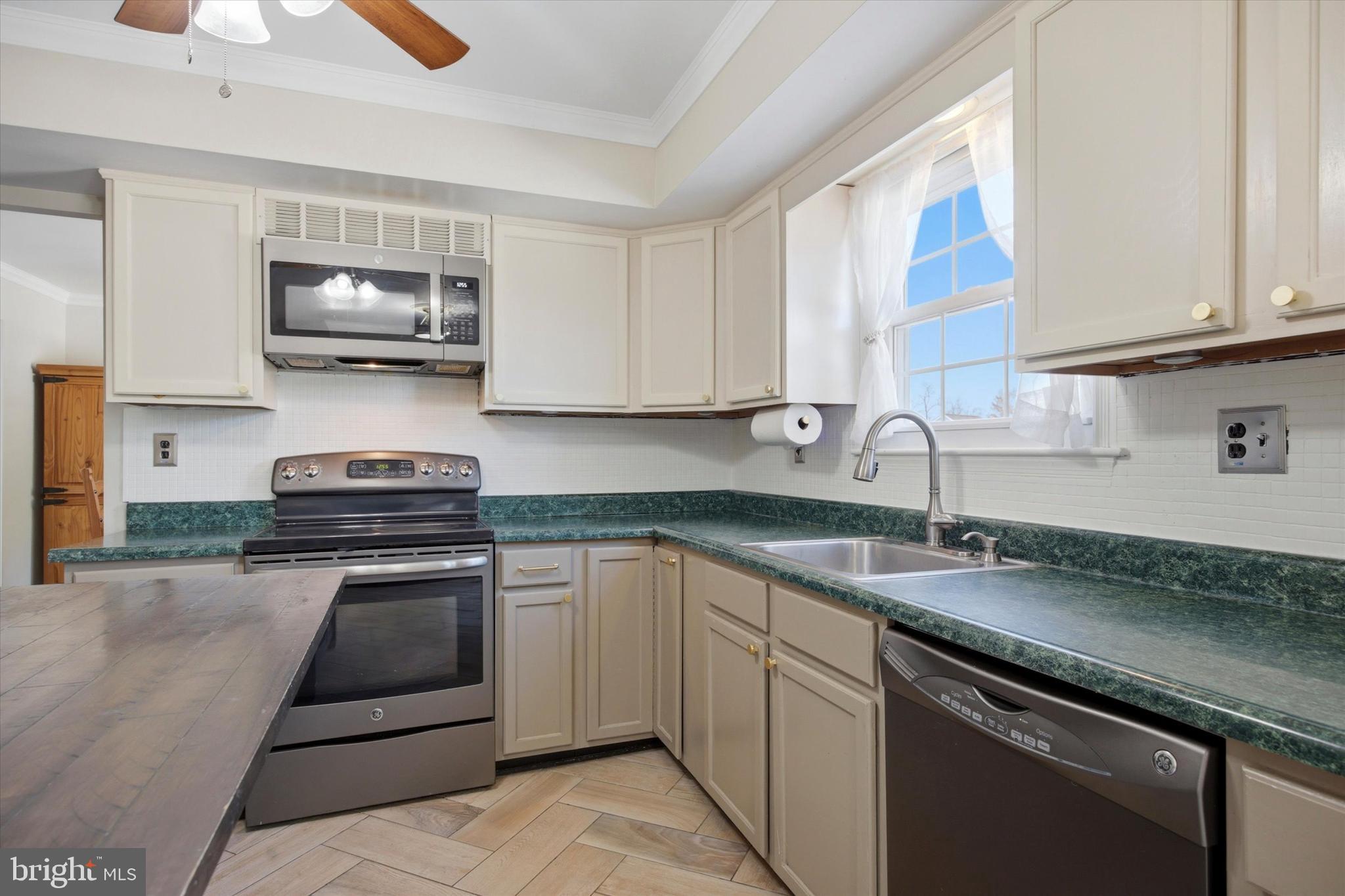 1 Country Village Way Media, PA 19063 - Photo 15 of 50 a kitchen with stainless steel appliances granite countertop a sink stove and microwave