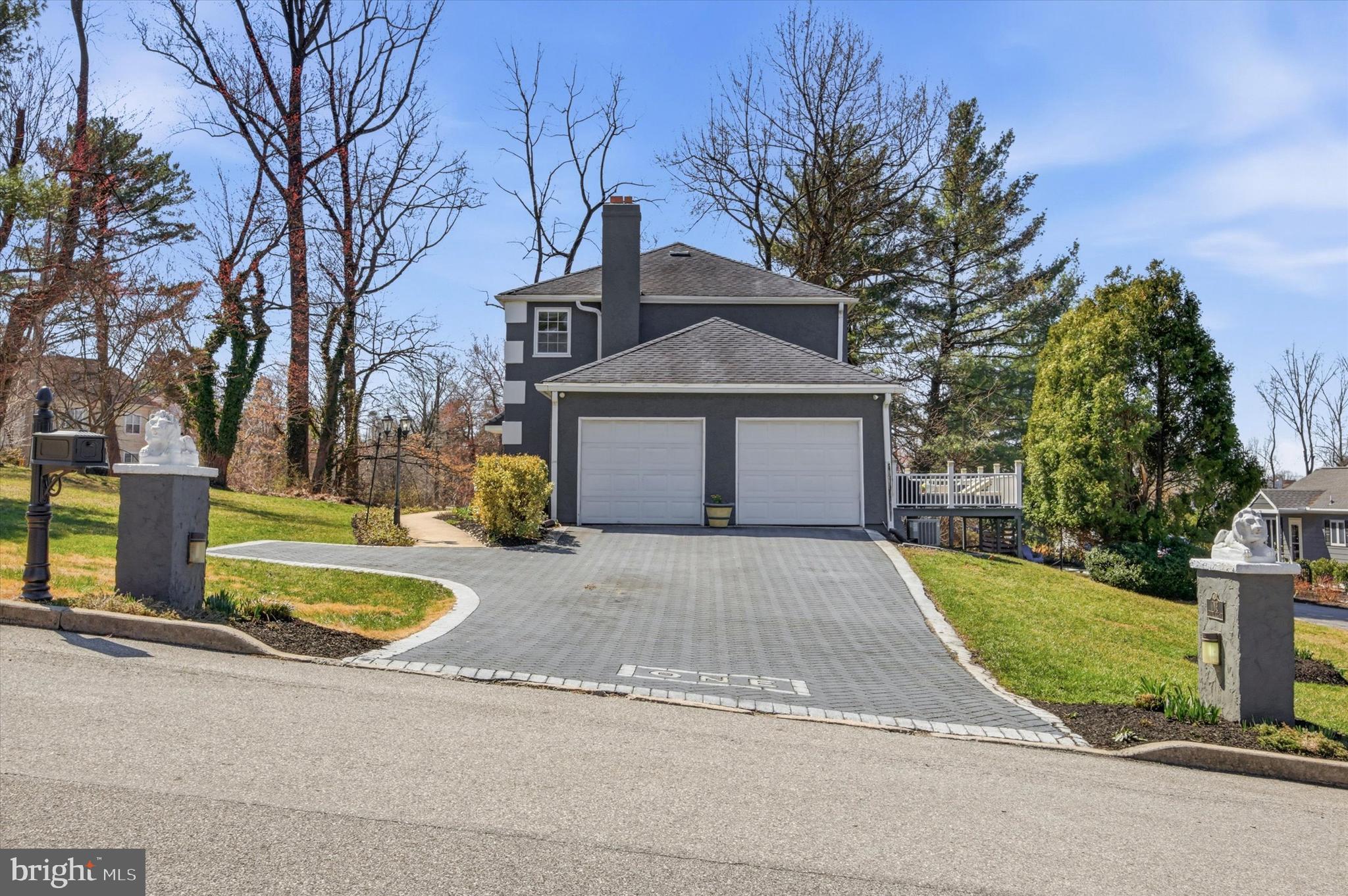 1 Country Village Way Media, PA 19063 - Photo 4 of 50 a front view of a house with a yard and garage