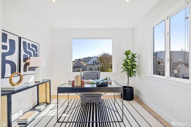 a living room with furniture and a potted plant