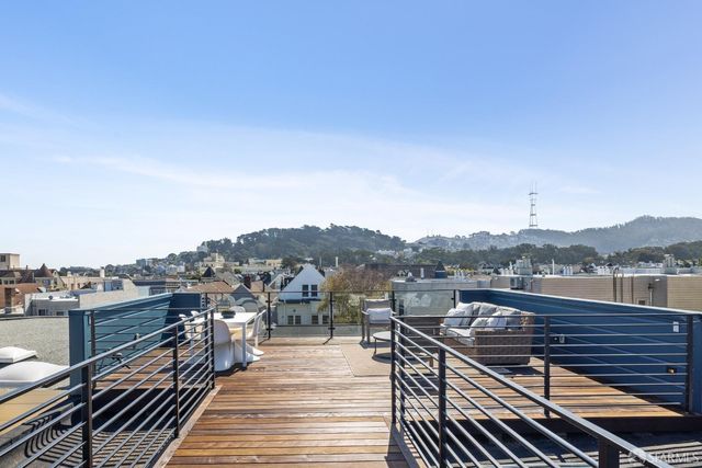 a view of a balcony with wooden floor and city view