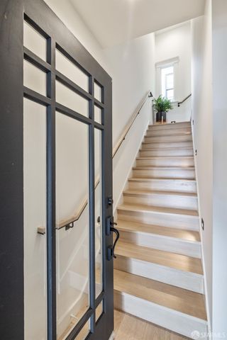 a view of entryway and hall with wooden floor
