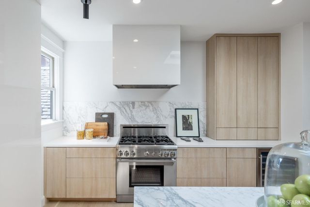 a kitchen with a stove and white cabinets