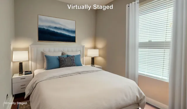 a large bed sitting in a bedroom next to a window