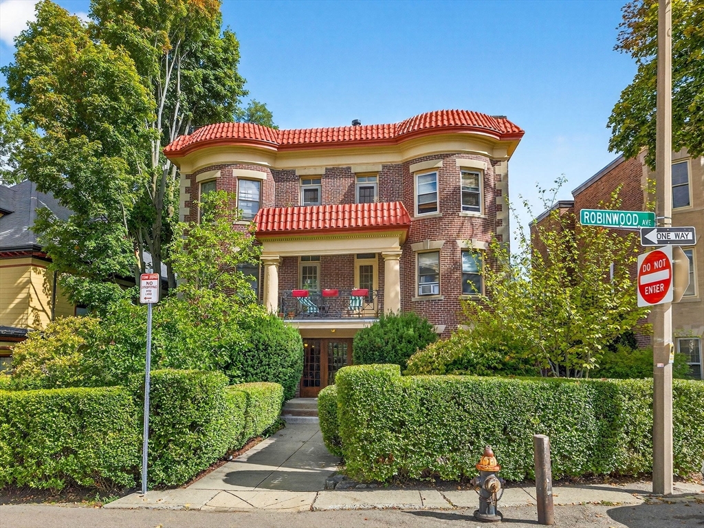32 Robinwood Avenue, Unit 7 Boston, MA 02130 - Photo 19 of 24 a front view of a house with a yard