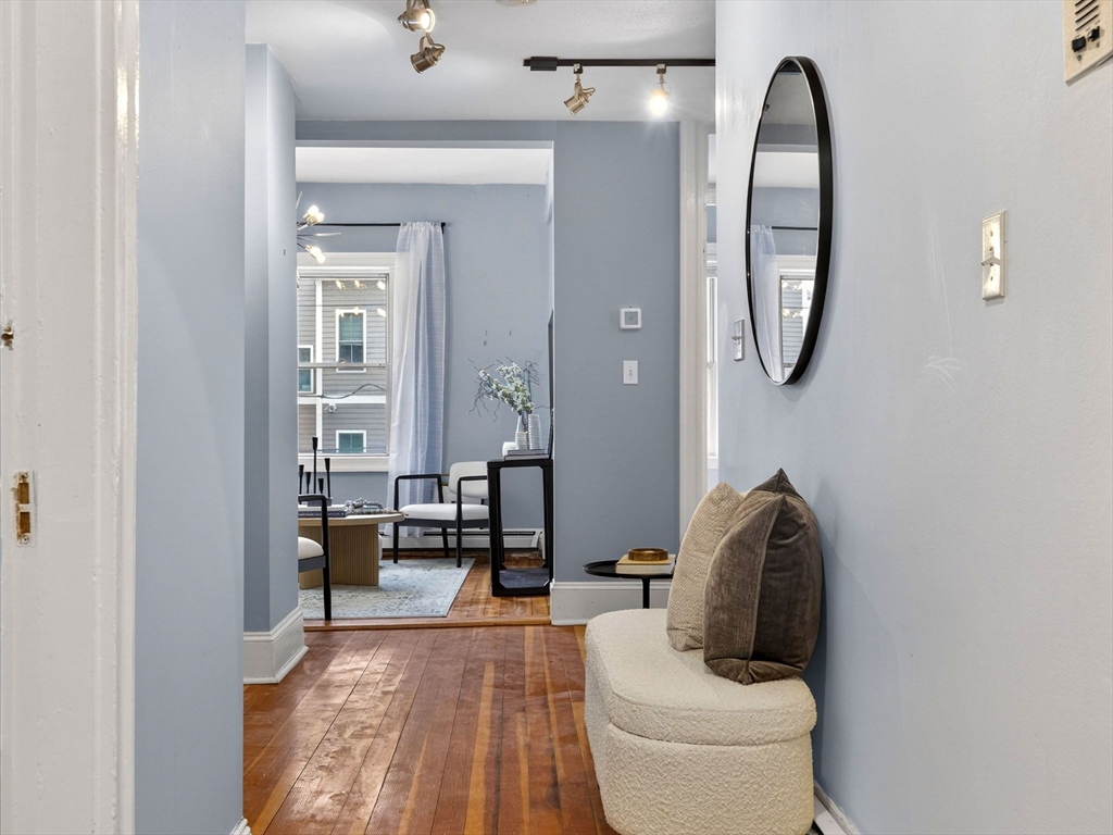 32 Robinwood Avenue, Unit 7 Boston, MA 02130 - Photo 8 of 24 a living room with furniture a mirror and a toilet next to a window