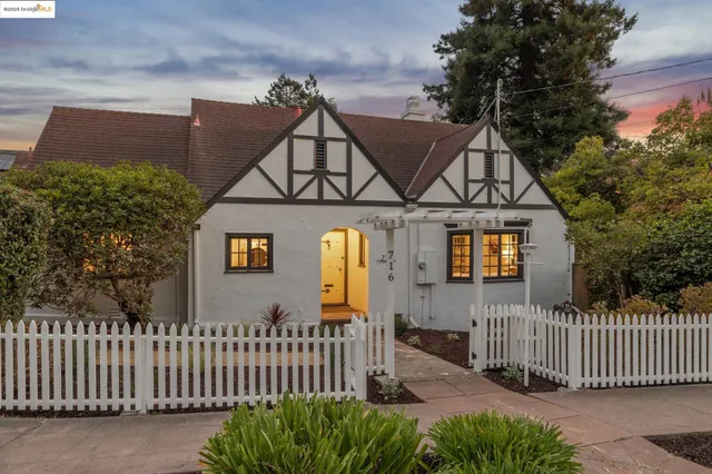 a front view of a house with iron fence