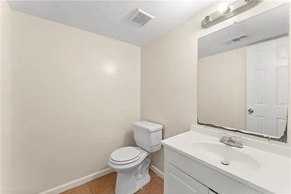 a bathroom with a sink a toilet and mirror