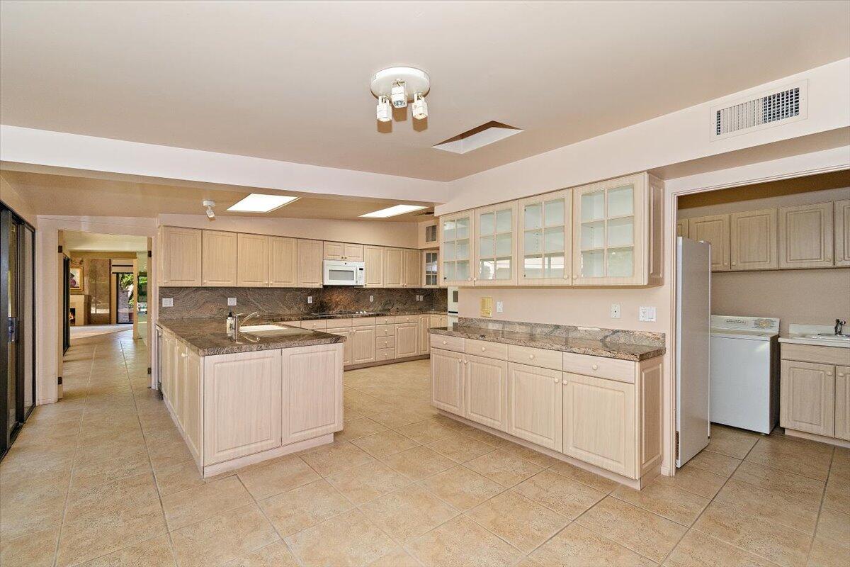 40885 Thunderbird Road Rancho Mirage, CA 92270 - Photo 17 of 61 a kitchen with white cabinets and appliances