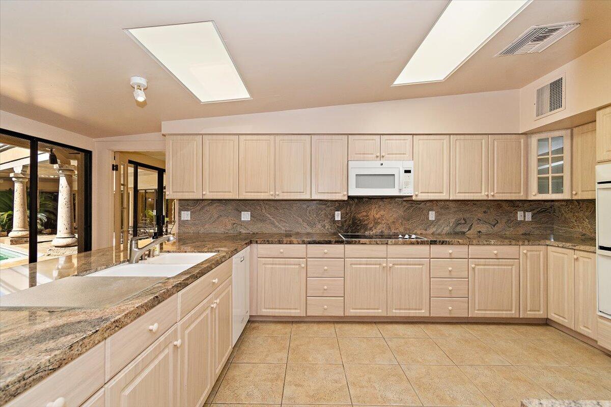 40885 Thunderbird Road Rancho Mirage, CA 92270 - Photo 18 of 61 a large kitchen with granite countertop a sink and cabinets