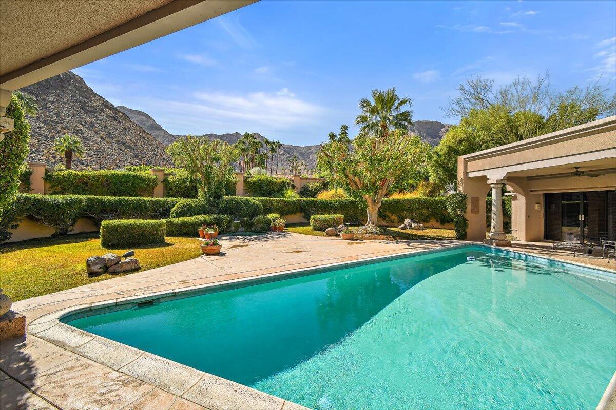 40885 Thunderbird Road Rancho Mirage, CA 92270 - Photo 22 of 61 a view of a swimming pool with a patio and a yard