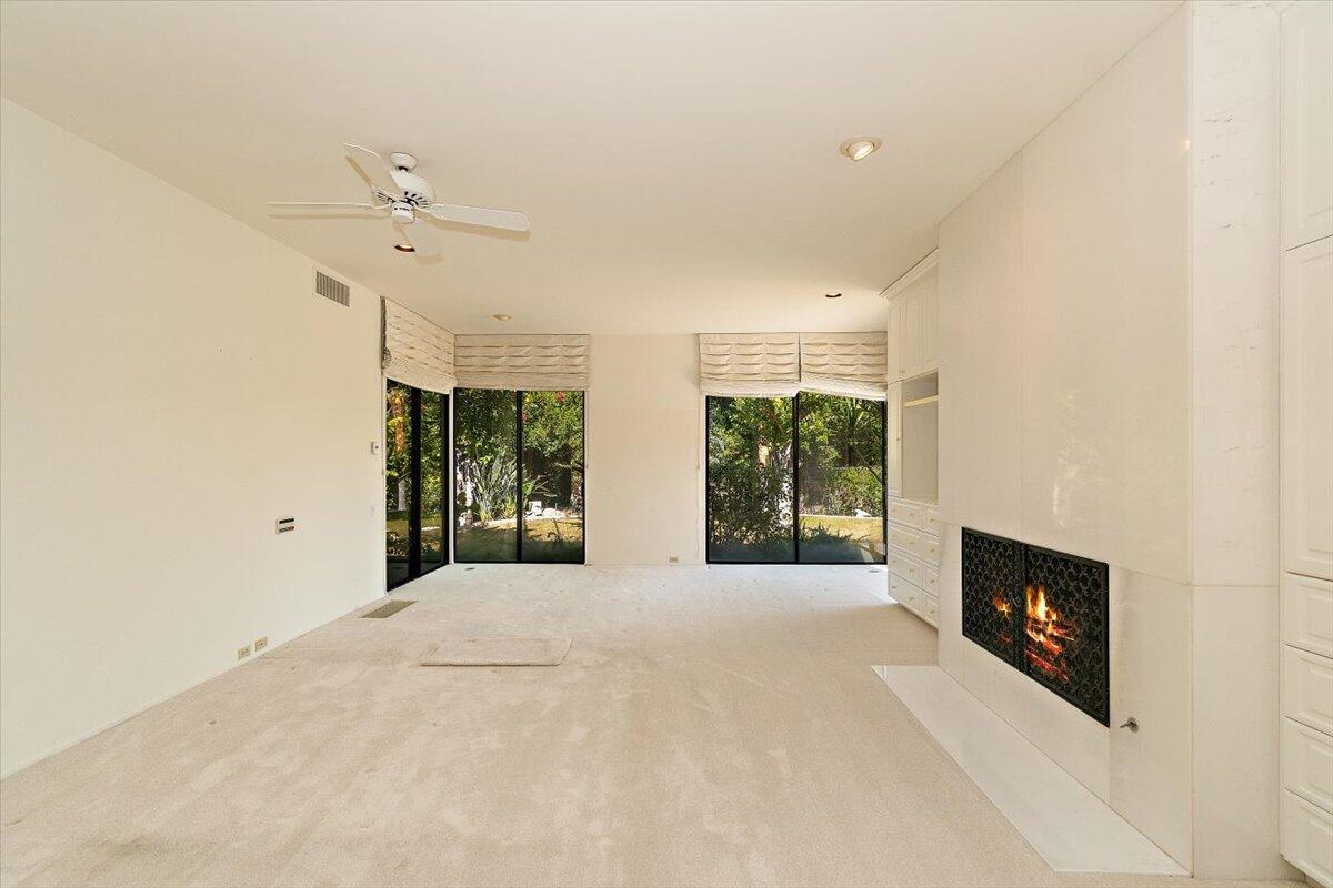 40885 Thunderbird Road Rancho Mirage, CA 92270 - Photo 28 of 61 a view of an empty room with a fireplace and a window