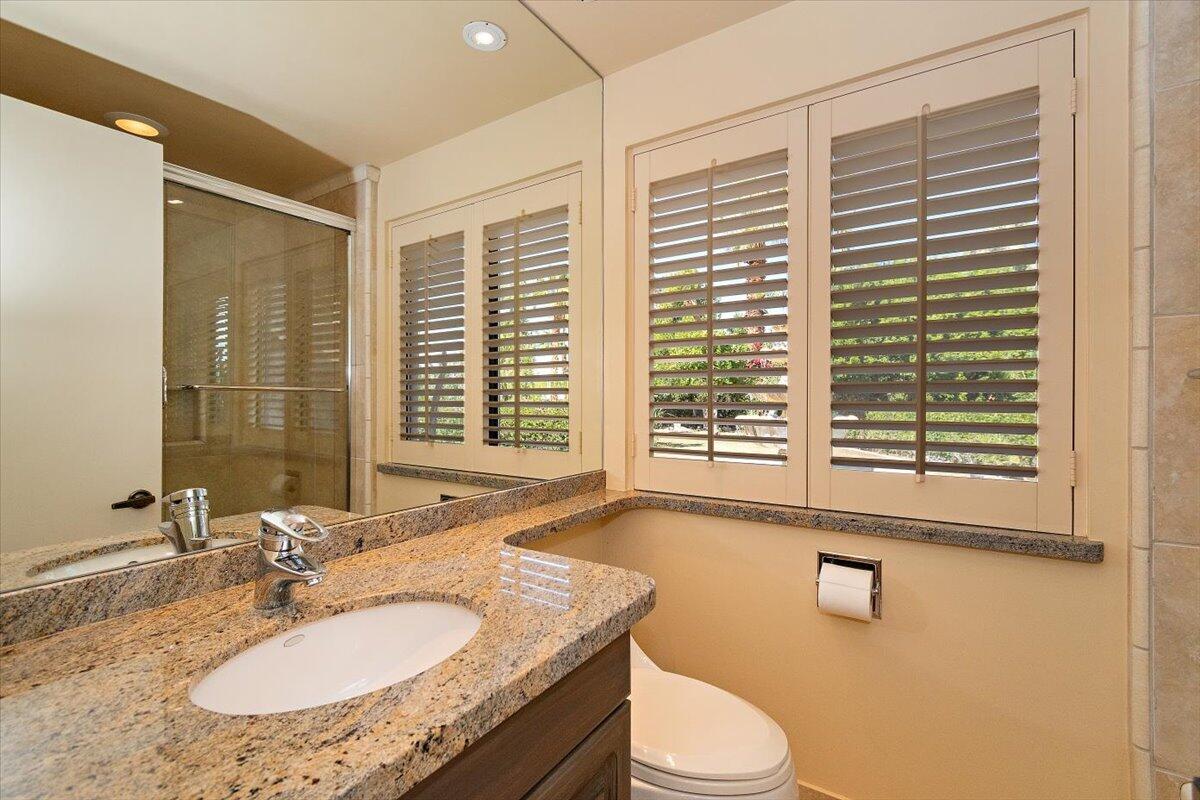 40885 Thunderbird Road Rancho Mirage, CA 92270 - Photo 29 of 61 a bathroom with a granite countertop sink and a mirror