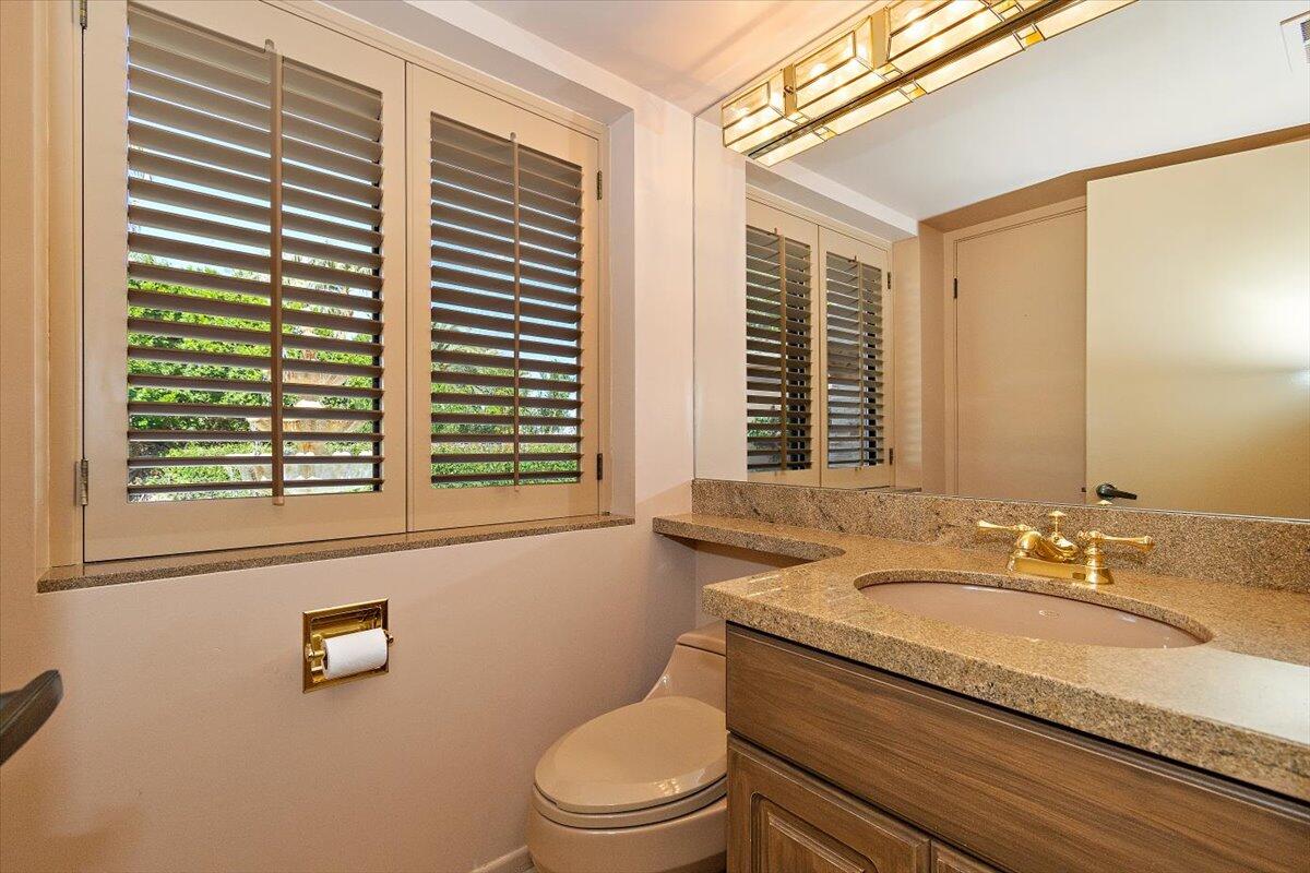 40885 Thunderbird Road Rancho Mirage, CA 92270 - Photo 30 of 61 a bathroom with a granite countertop sink and a mirror