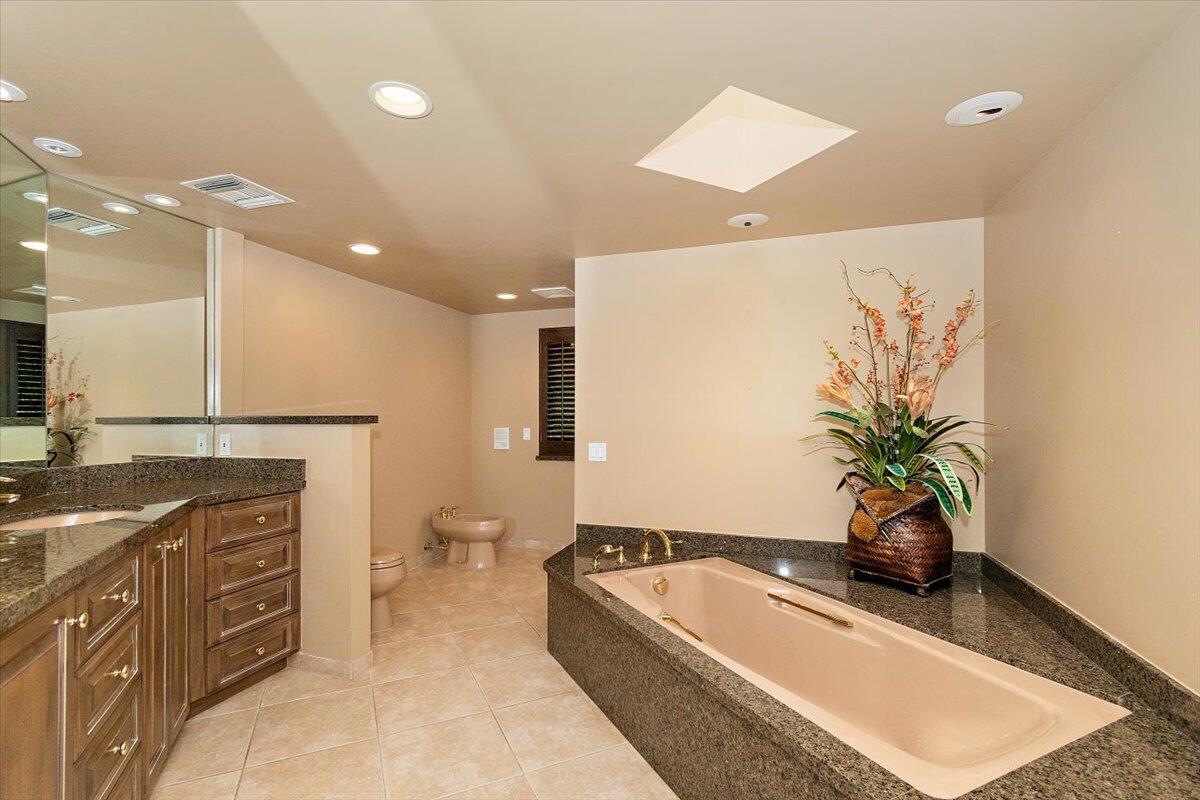 40885 Thunderbird Road Rancho Mirage, CA 92270 - Photo 35 of 61 a spacious bathroom with a double vanity sink a large mirror and a shower