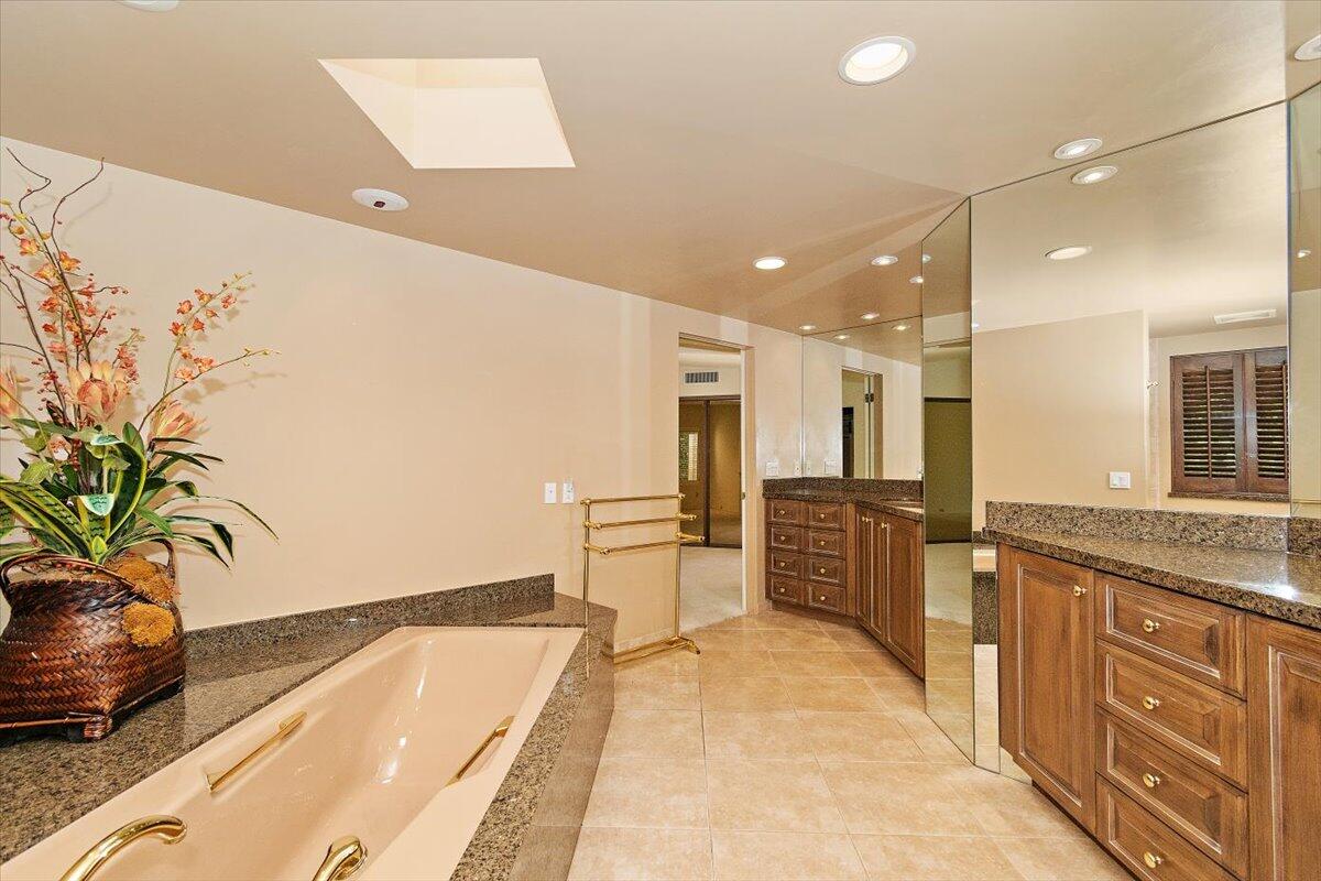 40885 Thunderbird Road Rancho Mirage, CA 92270 - Photo 36 of 61 a spacious bathroom with a tub and sink