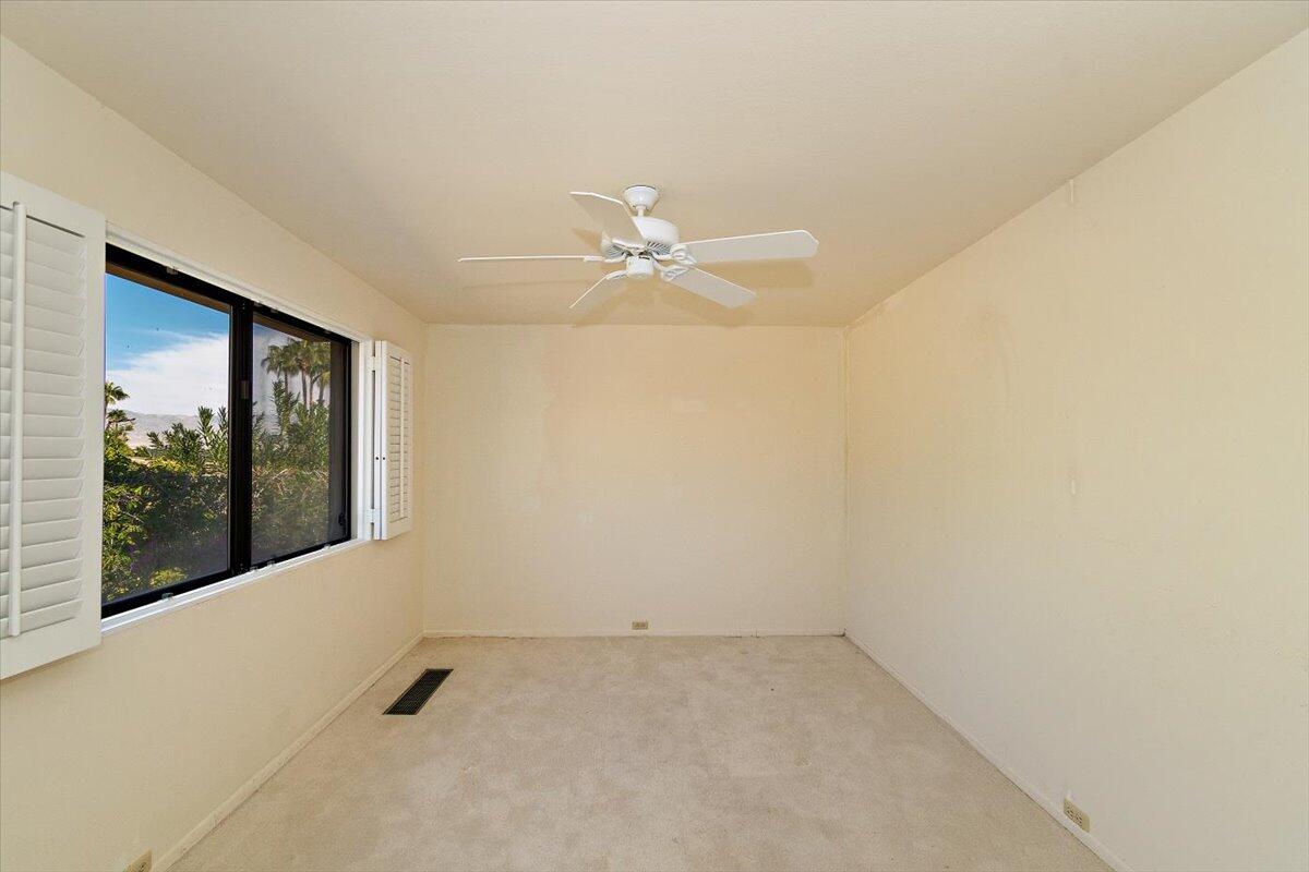 40885 Thunderbird Road Rancho Mirage, CA 92270 - Photo 55 of 61 an empty room with a ceiling fan and window