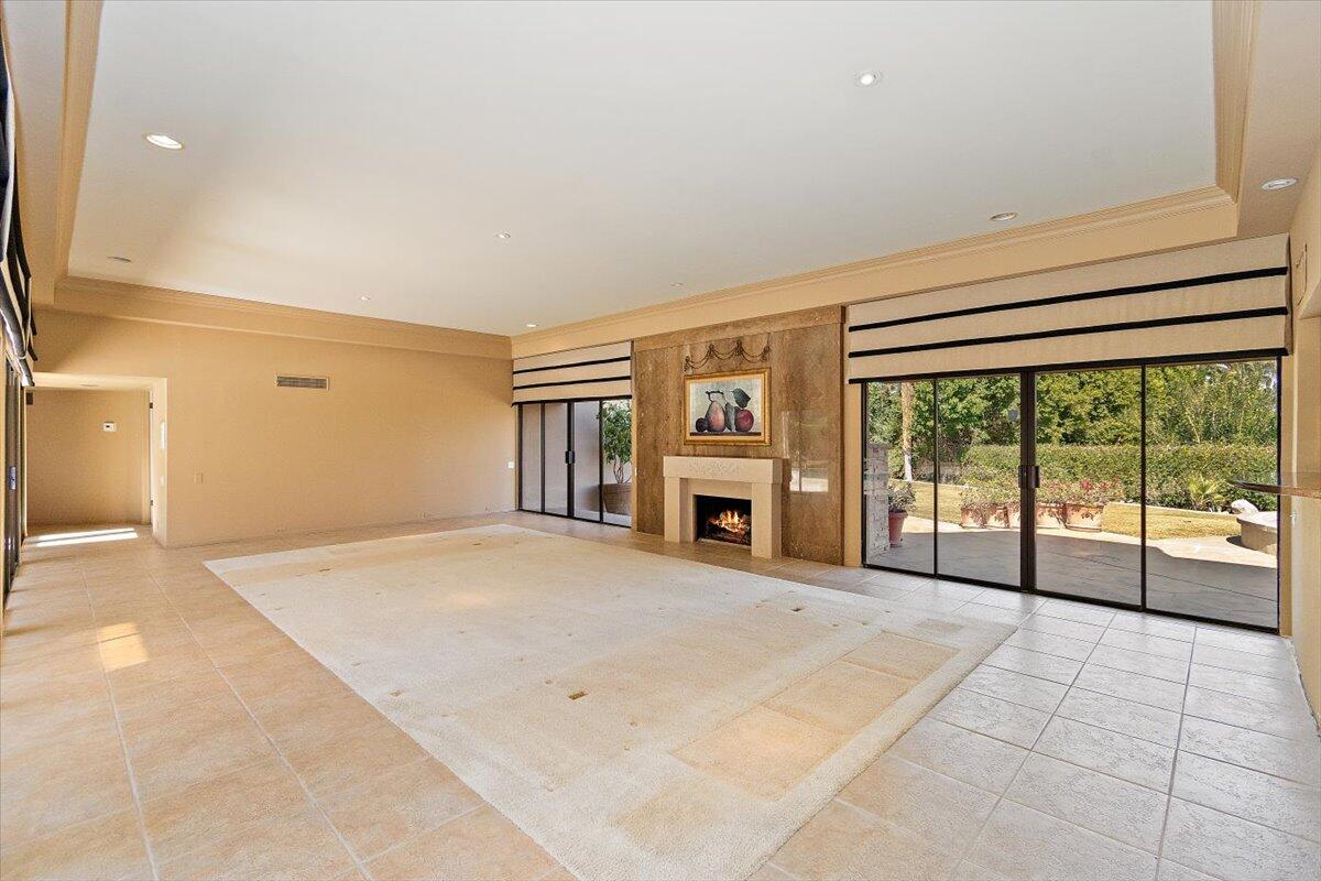 40885 Thunderbird Road Rancho Mirage, CA 92270 - Photo 7 of 61 a view of an empty room with a fireplace and a large window