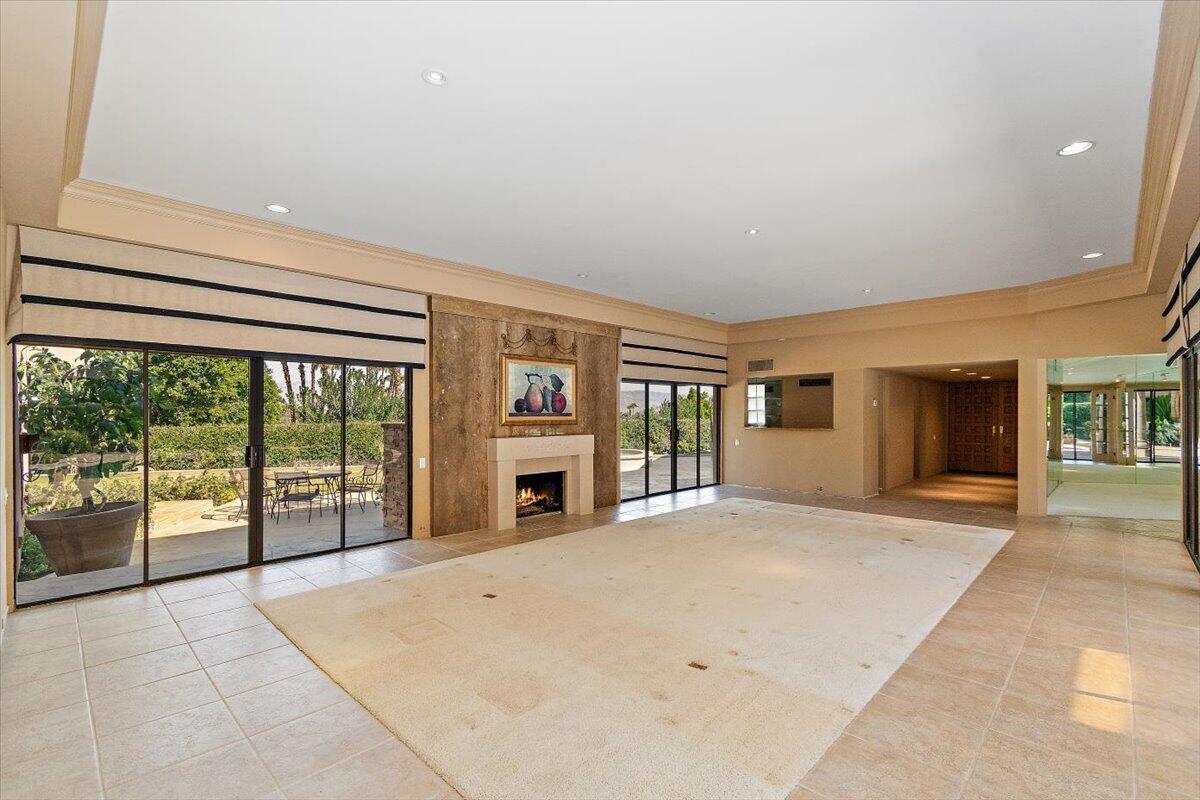 40885 Thunderbird Road Rancho Mirage, CA 92270 - Photo 9 of 61 wooden floor in an empty room with a fireplace and a window