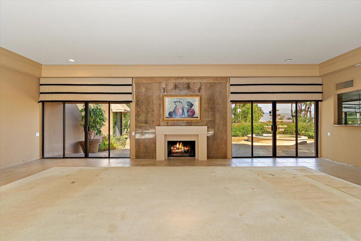 40885 Thunderbird Road Rancho Mirage, CA 92270 - Photo 10 of 61 a view of an empty room with a fireplace and a window