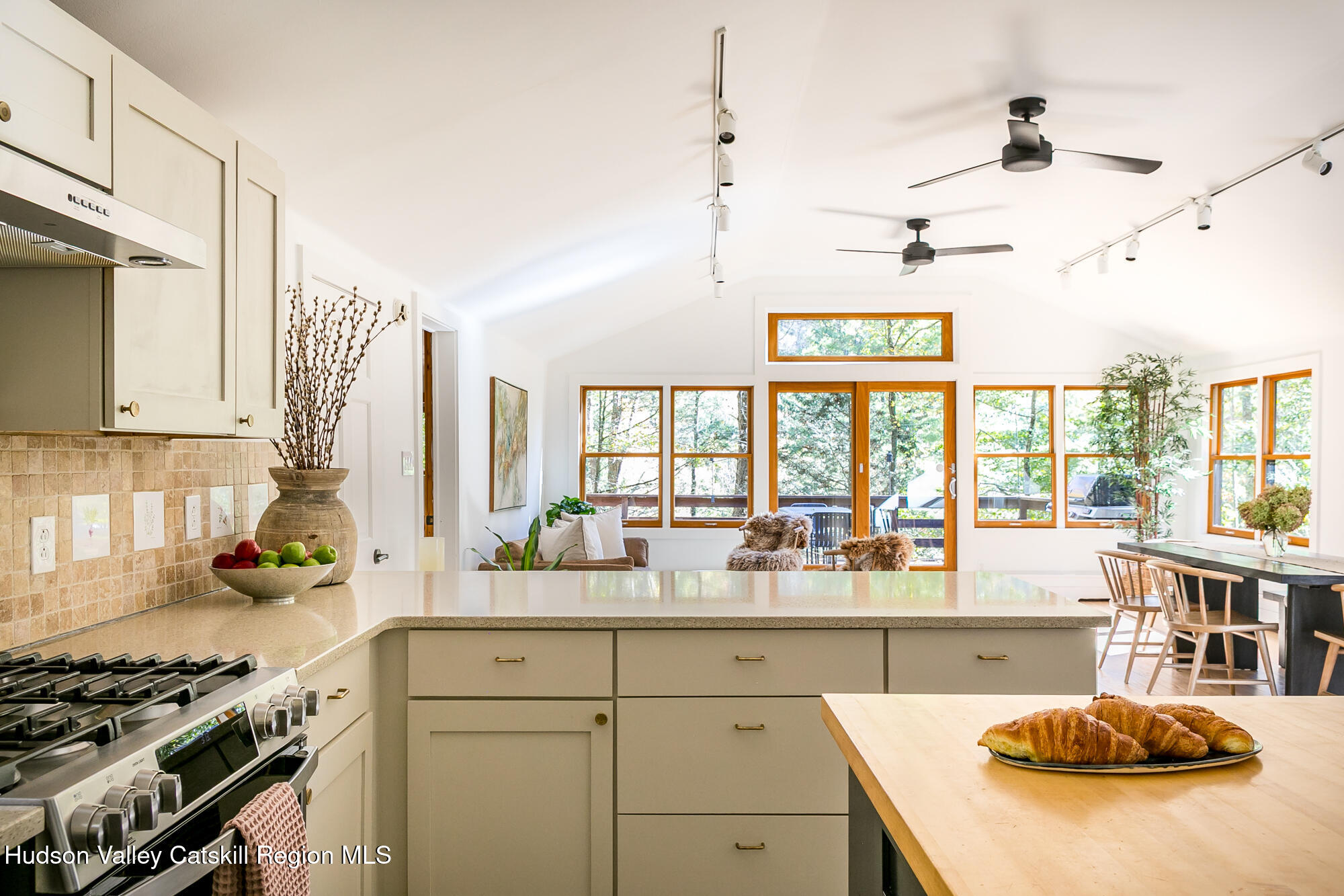 439 Silver Hollow Road Chichester, NY 12416 - Photo 11 of 36 a kitchen with stainless steel appliances kitchen island wooden cabinets a stove a sink and a large window